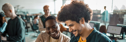 Close up of a group of students in the university working on their computers