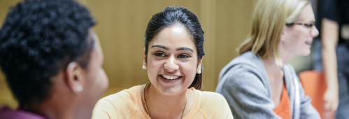 Two women smiling during a conversation