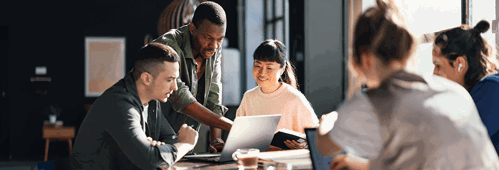 Young professionals looking at laptop
