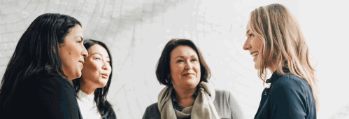 Four colleagues smiling in a group