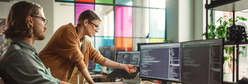 Caucasian Man and Woman Discussing New Features For Artificial Inteligence Software.