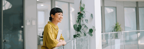Female looking out over office staircase