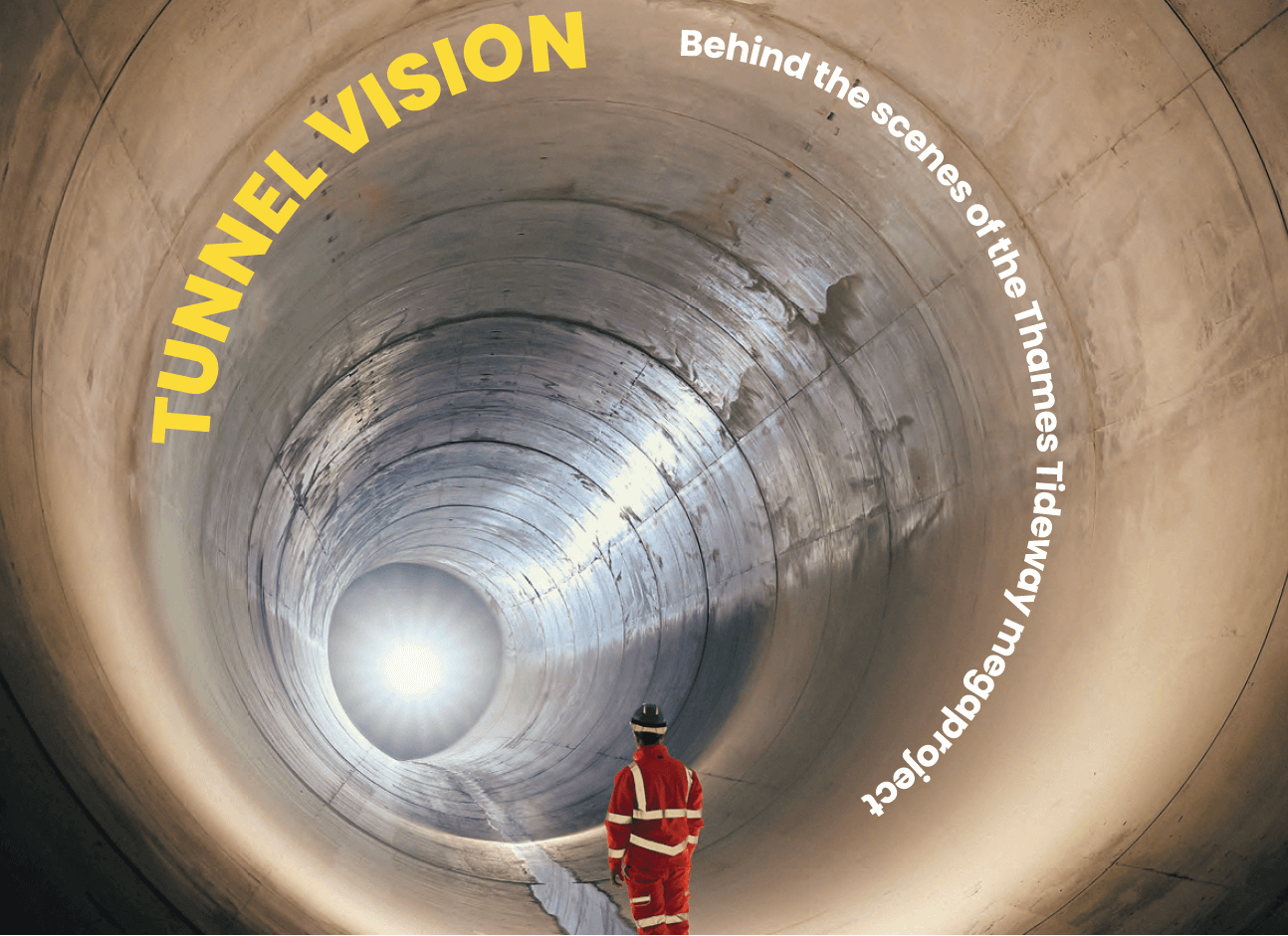 Man in workers overalls standing in a huge underground tunnel